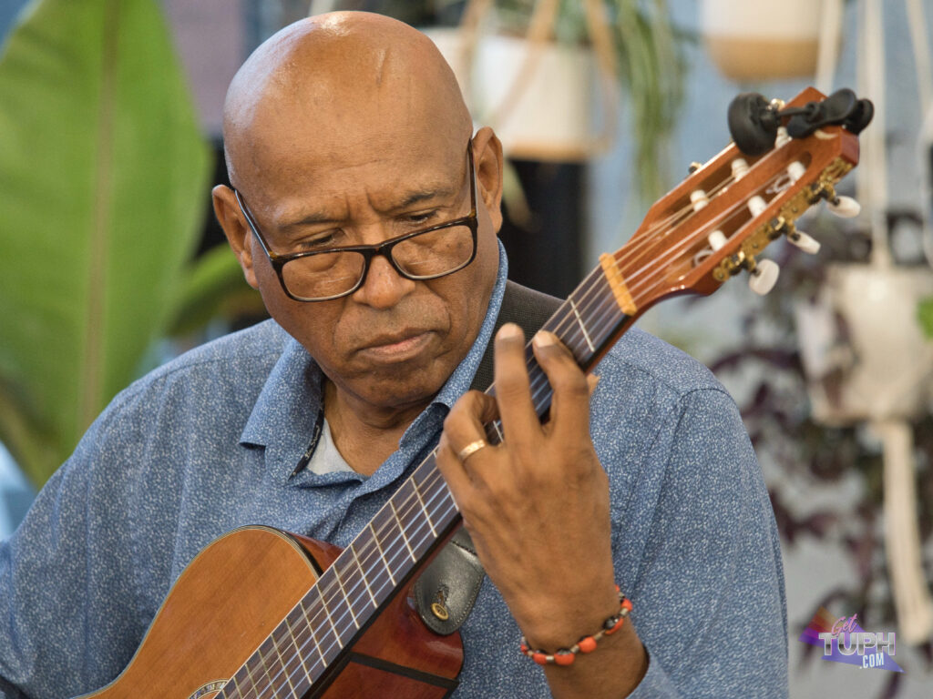 Hector Mendoza, a classical guitarist, playing a six stringed guitar.